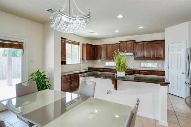 112 Bearing Cv, Austin, TX 78717 - kitchen with visible vents, backsplash, a wealth of natural light, and a center island