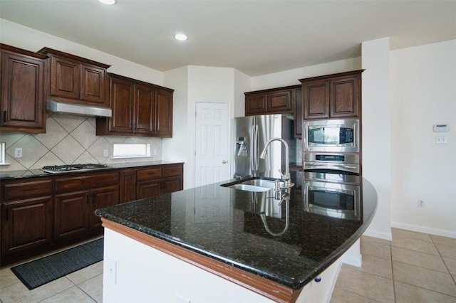 112 Bearing Cv, Austin, TX 78717 - kitchen featuring tasteful backsplash, a sink, dark stone countertops, under cabinet range hood, and stainless steel appliances