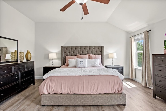 bedroom featuring baseboards, light wood finished floors, ceiling fan, and vaulted ceiling