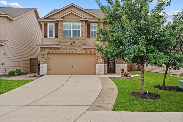 craftsman house featuring stone siding, a front yard, brick siding, an attached garage, and driveway