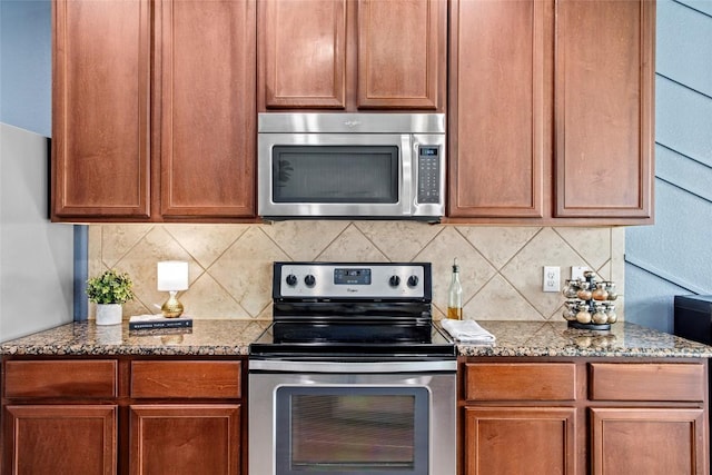 kitchen with stone counters, backsplash, stainless steel appliances, and brown cabinetry