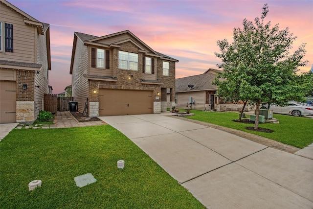craftsman-style home featuring a front lawn, fence, brick siding, concrete driveway, and an attached garage