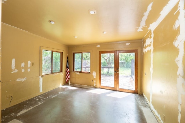 unfurnished room featuring concrete floors, french doors, recessed lighting, baseboards, and ornamental molding