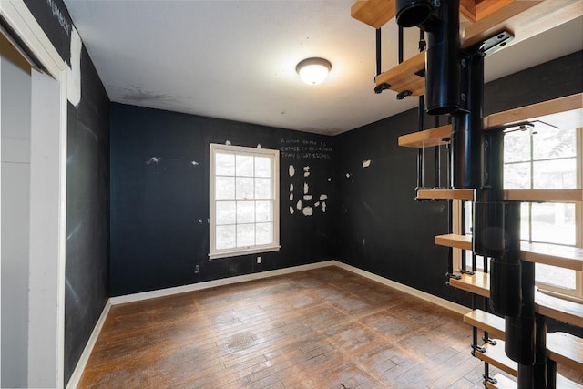 empty room featuring baseboards and hardwood / wood-style floors