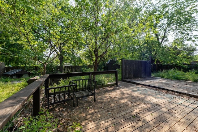 wooden terrace with a fenced backyard