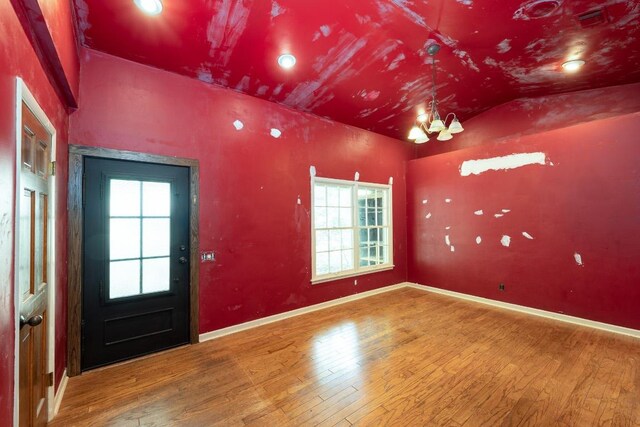 2907 Pinecrest Dr, Austin, TX 78757 - foyer with hardwood / wood-style floors, vaulted ceiling, baseboards, and a chandelier