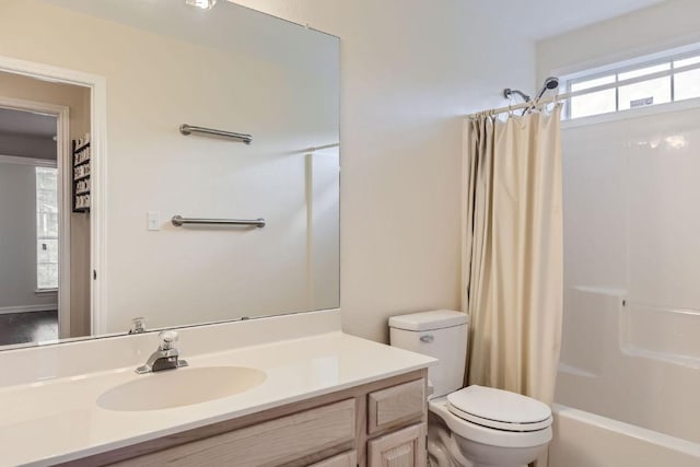 full bathroom with vanity, shower / bathtub combination with curtain, and toilet