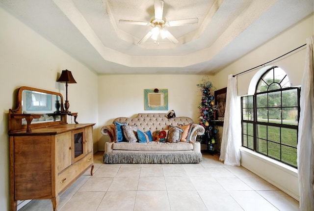 903 Hackberry St, Bandera, TX 78003 - living room with a tray ceiling, ceiling fan, light tile patterned floors, and baseboards