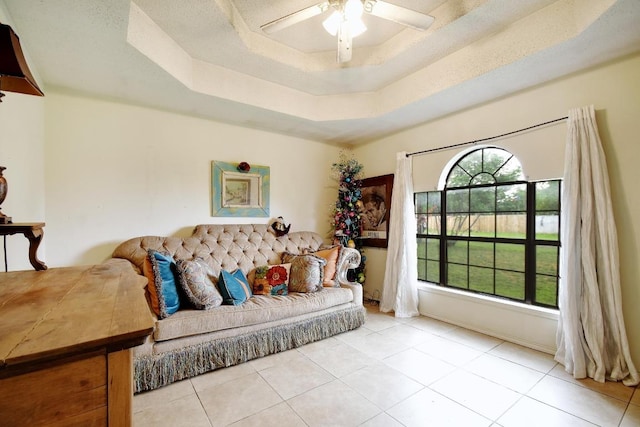 903 Hackberry St, Bandera, TX 78003 - tiled living room featuring ceiling fan and a raised ceiling
