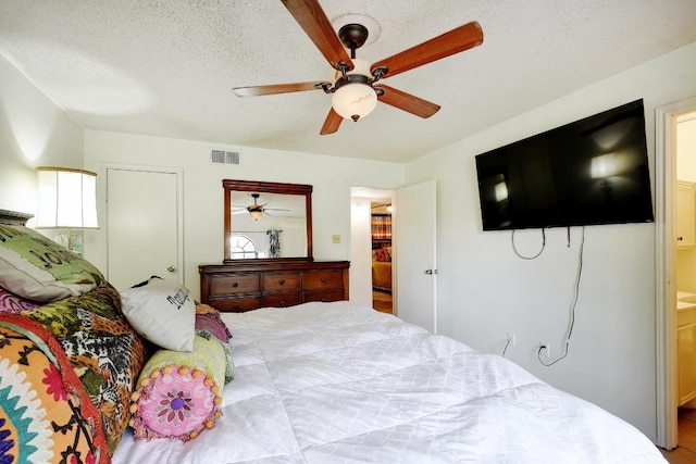 bedroom featuring visible vents, a ceiling fan, a textured ceiling, and multiple windows