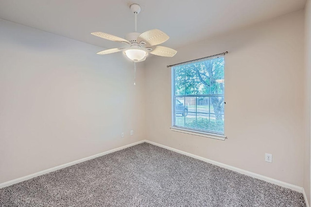 empty room with baseboards, ceiling fan, and carpet