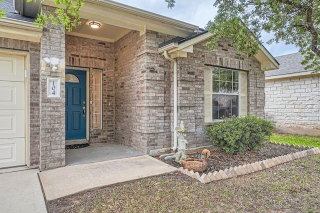 doorway to property with brick siding