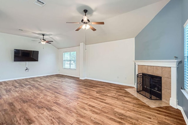 unfurnished living room with ceiling fan, visible vents, wood finished floors, and lofted ceiling
