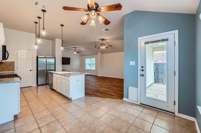 kitchen featuring visible vents, open floor plan, ceiling fan, and lofted ceiling