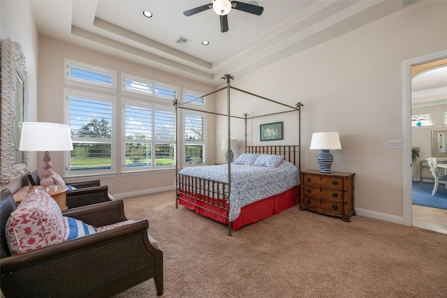 228 Cimarron Hills Trl E, Georgetown, TX 78628 - bedroom with carpet, a tray ceiling, arched walkways, recessed lighting, and a ceiling fan
