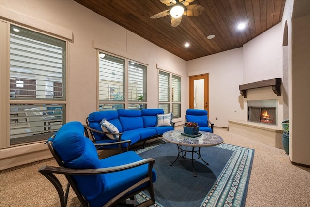 228 Cimarron Hills Trl E, Georgetown, TX 78628 - living area with carpet flooring, wooden ceiling, a lit fireplace, a ceiling fan, and plenty of natural light
