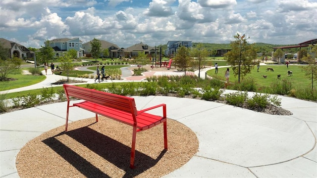 view of community featuring a lawn and a residential view