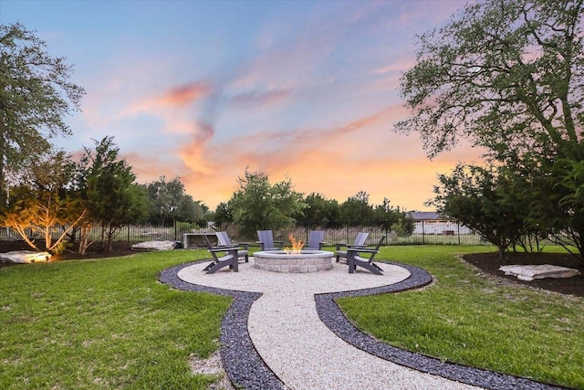 view of home's community with a patio, a fire pit, fence, and a yard