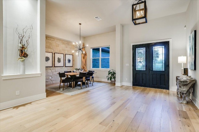 1117 Eagle Point Dr, Georgetown, TX 78628 - entrance foyer with wood finished floors, a chandelier, and baseboards