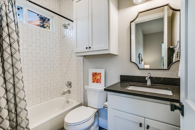 bathroom with toilet, a healthy amount of sunlight, shower / tub combo, and vanity