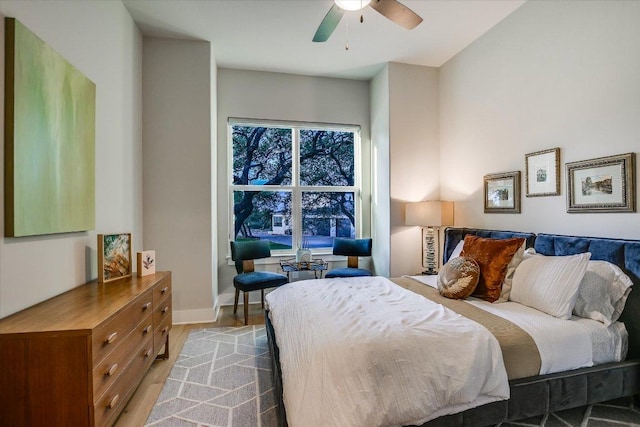 bedroom with baseboards, ceiling fan, and wood finished floors