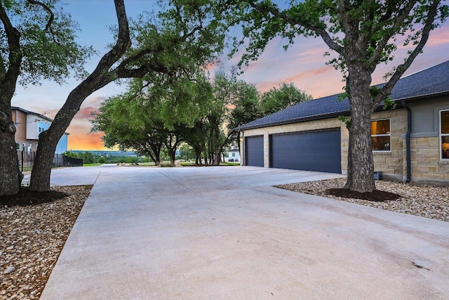 1117 Eagle Point Dr, Georgetown, TX 78628 - view of side of home featuring driveway, stone siding, and an attached garage
