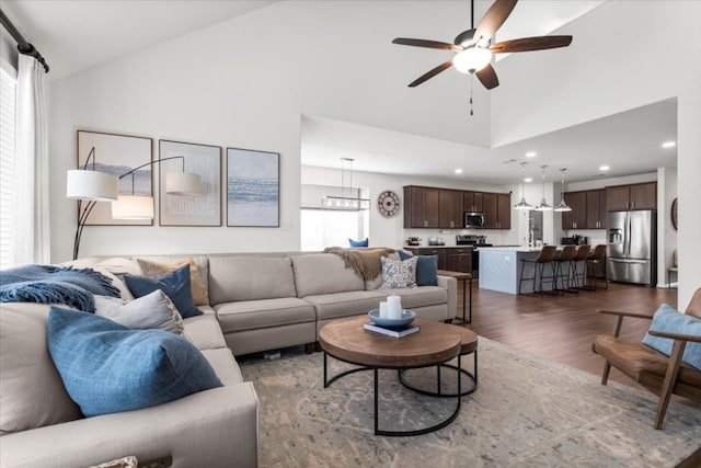 6401 Golden Bough Ln, Pflugerville, TX 78660 - living area with dark wood-type flooring, a ceiling fan, high vaulted ceiling, recessed lighting, and a chandelier