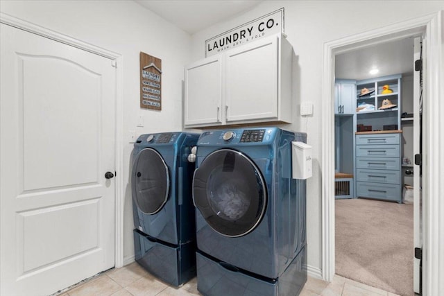 6401 Golden Bough Ln, Pflugerville, TX 78660 - laundry area with cabinet space, separate washer and dryer, and light tile patterned floors
