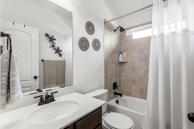 bathroom with vanity, shower / bath combo, and toilet