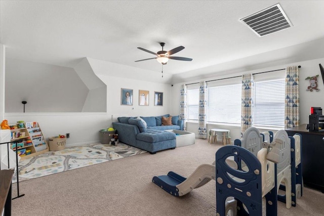 living area featuring carpet floors, ceiling fan, and visible vents