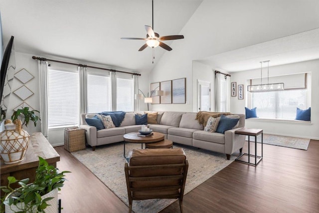 living room featuring baseboards, ceiling fan, wood finished floors, and high vaulted ceiling