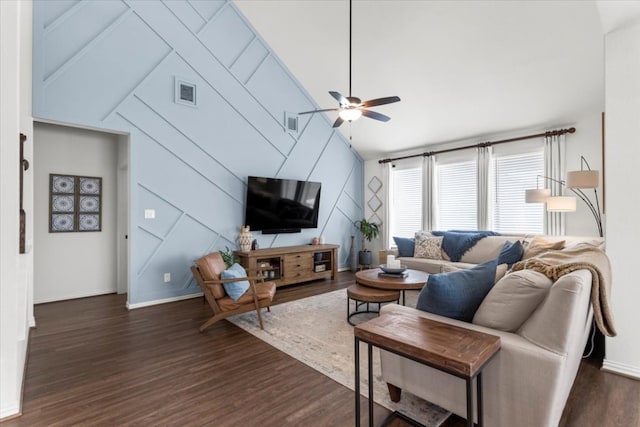 living room featuring ceiling fan, visible vents, dark wood finished floors, baseboards, and vaulted ceiling