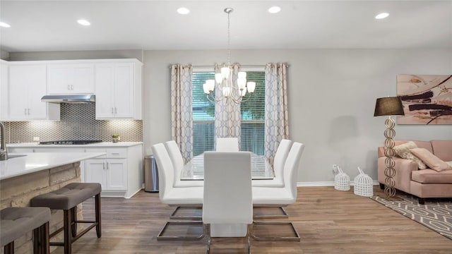 1621 Winding Stream Trl, Leander, TX 78641 - dining space featuring a chandelier, wood finished floors, recessed lighting, and baseboards
