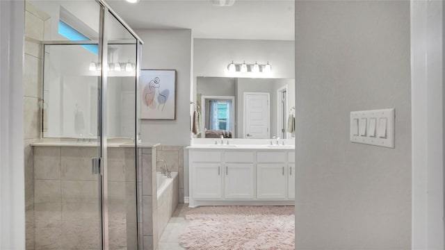 1621 Winding Stream Trl, Leander, TX 78641 - bathroom featuring a stall shower, a garden tub, vanity, and tile patterned floors