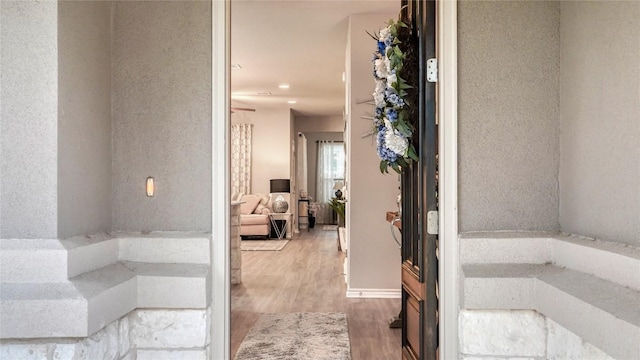 interior space featuring recessed lighting, baseboards, and wood finished floors