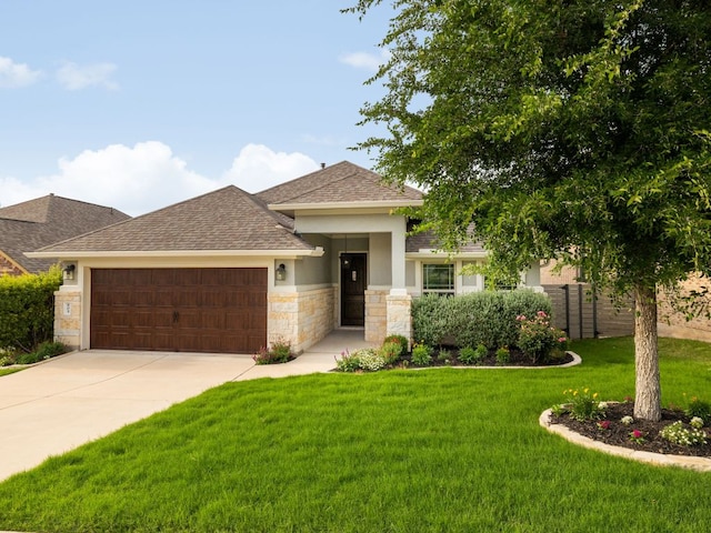 view of front facade with a garage, stone siding, a front yard, roof with shingles, and driveway
