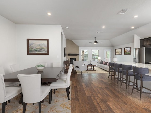 dining area featuring ceiling fan, a fireplace, recessed lighting, wood finished floors, and visible vents