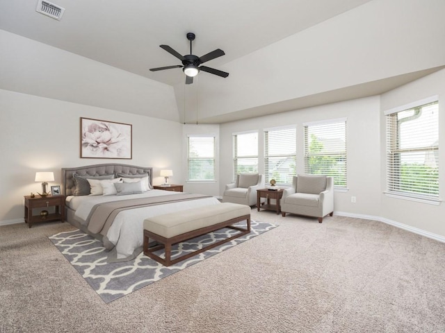bedroom featuring baseboards, light colored carpet, lofted ceiling, and visible vents