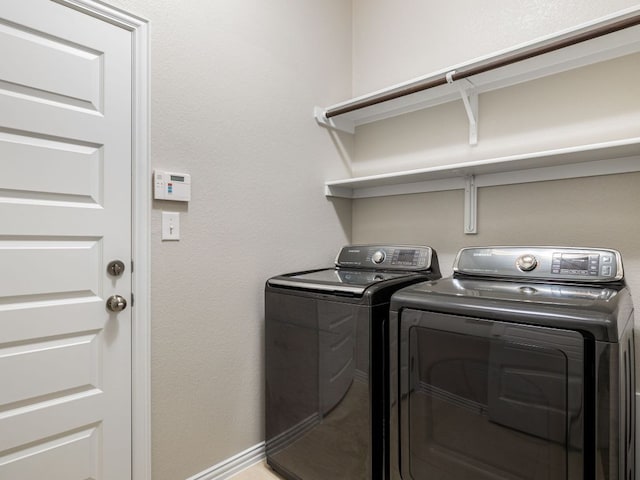 laundry room featuring washer and dryer, laundry area, and baseboards