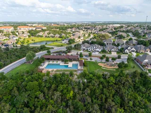 birds eye view of property with a water view and a residential view