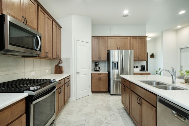kitchen with visible vents, decorative backsplash, recessed lighting, a sink, and appliances with stainless steel finishes