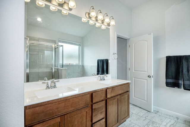 532 Tanda Ln, Hutto, TX 78634 - bathroom featuring double vanity, a stall shower, and marble look tile flooring