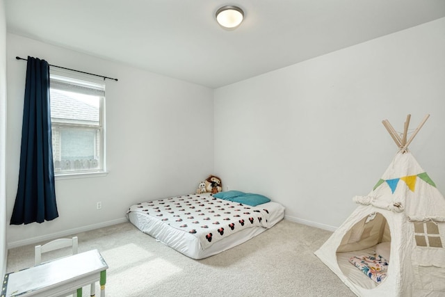 carpeted bedroom featuring baseboards