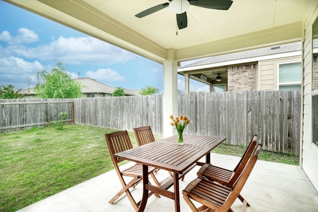 view of patio with outdoor dining area, a ceiling fan, and a fenced backyard