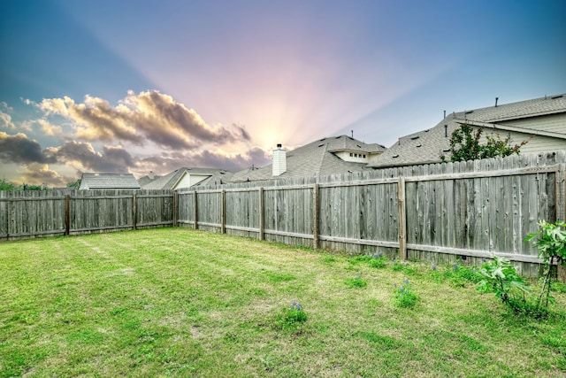 view of yard with a fenced backyard