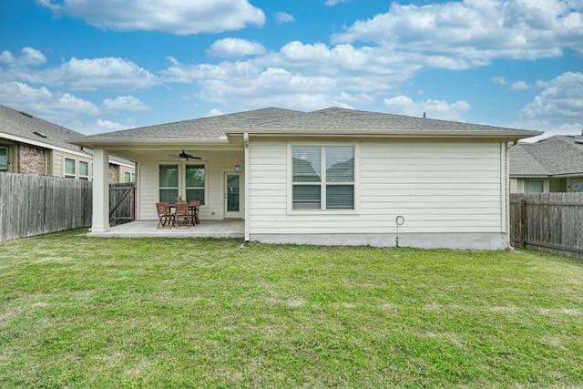 back of property featuring a fenced backyard, a ceiling fan, and a yard