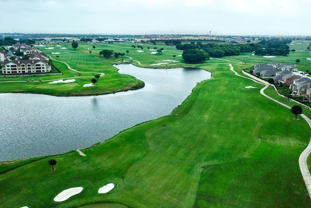 birds eye view of property with a water view and view of golf course