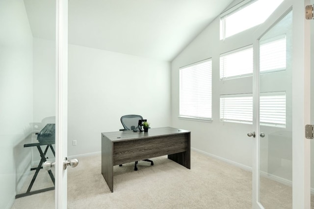 office with light colored carpet, baseboards, and vaulted ceiling