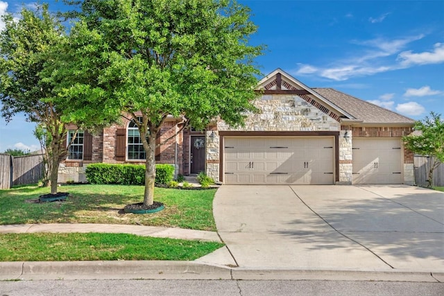 obstructed view of property with fence, an attached garage, a front lawn, stone siding, and concrete driveway