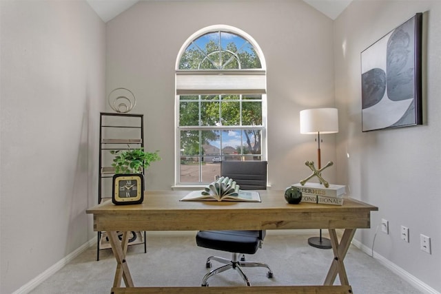 carpeted home office with baseboards and lofted ceiling